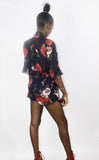 The 'LILLY ROSE' chiffon navy blue playsuit with red rose floral print and frill edge detail. Faith-Sherrelle
