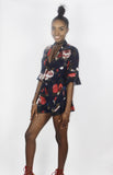 The 'LILLY ROSE' chiffon navy blue playsuit with red rose floral print and frill edge detail. Faith-Sherrelle