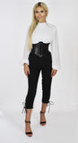 The 'KOURT' black high waisted, 3/4 length lace up leg jumpsuit, with its contrast white pleated upper body  blouse, high neckand balloon sleeves.